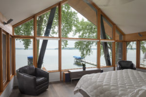 beautiful lake view master bedroom triple glaze Loewen windows rift sawn oak floor with rubio monocoat finish