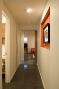 Hallway in finished basement after an underpin of the foundation to create beautiful living space.